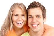 A female and a male smiling with white teeth