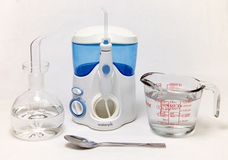 Waterpik water flosser, water jug and spoon